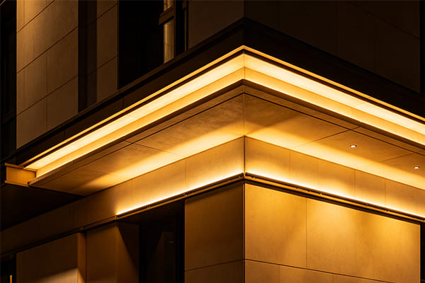 Facade showing different layers of brightness from eave lighting